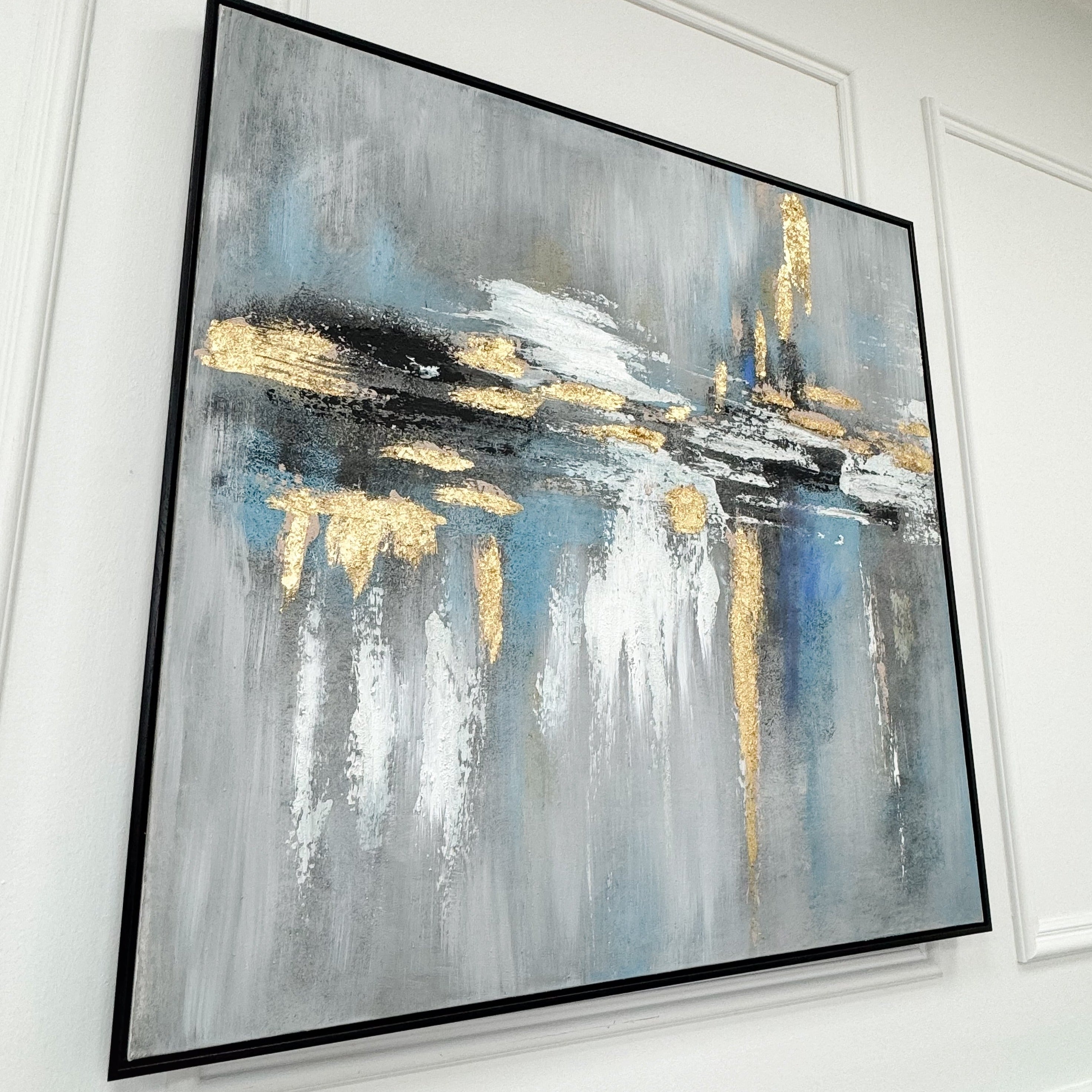 Toile abstraite encadrée noire aux tons dorés et bleus